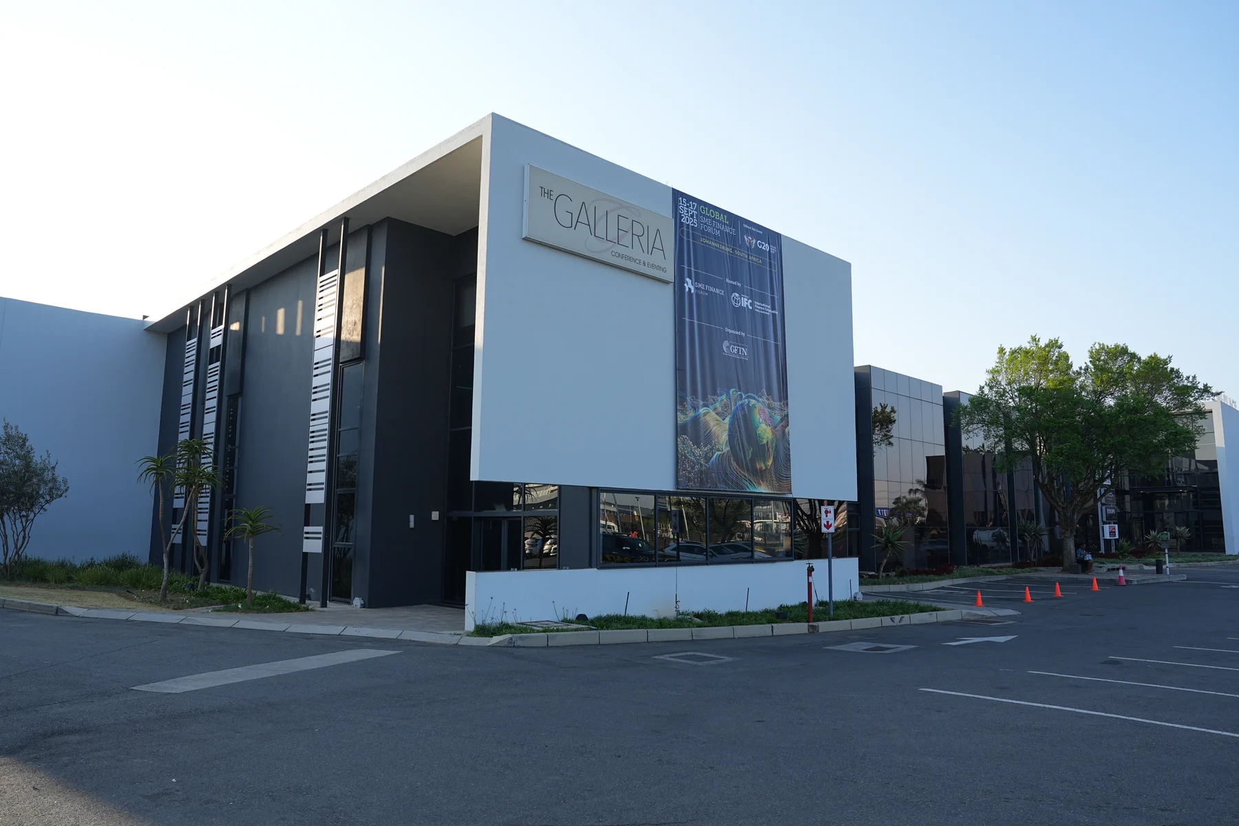 Global SME Finance Forum 2025’s globe key visual on a large exterior banner at the venue