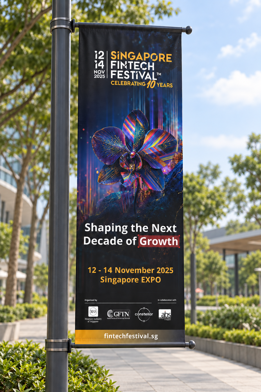 Presentation mockup of the SFF 2025 orchid banner mounted on a street lamp beside a landscaped urban walkway